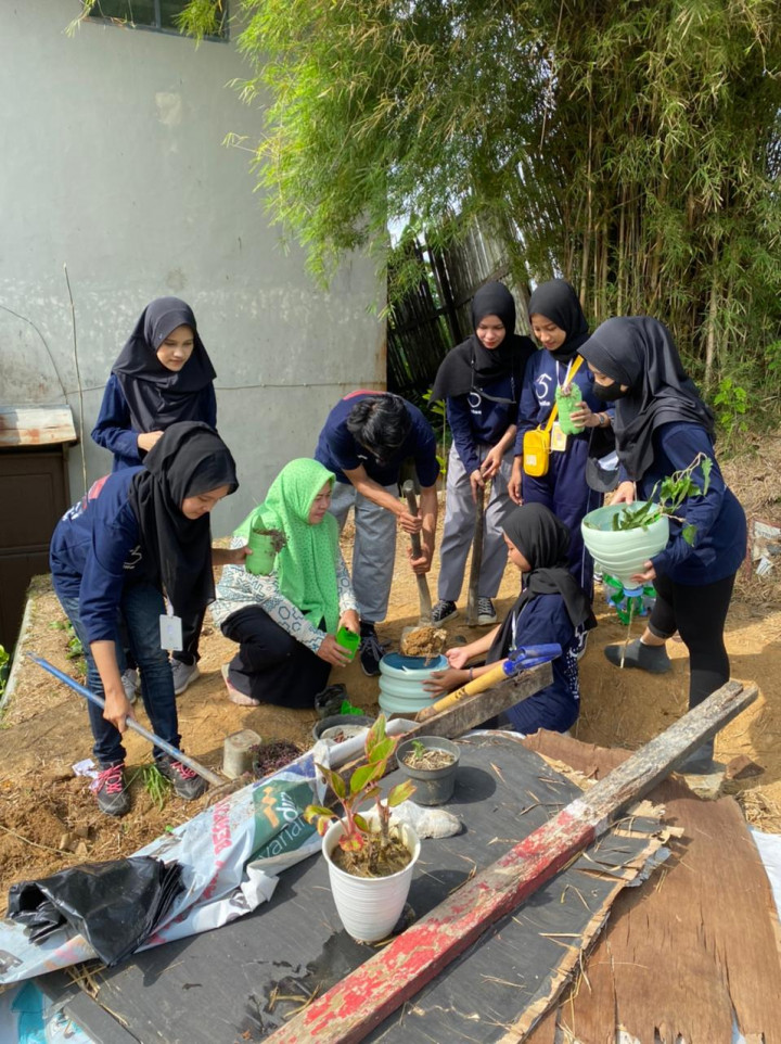 Gotong royong dan menanam Toga dihalaman belakang kantor Kelurahan bersama Lurah, Staff dan KKN Universitas Mulawarman
