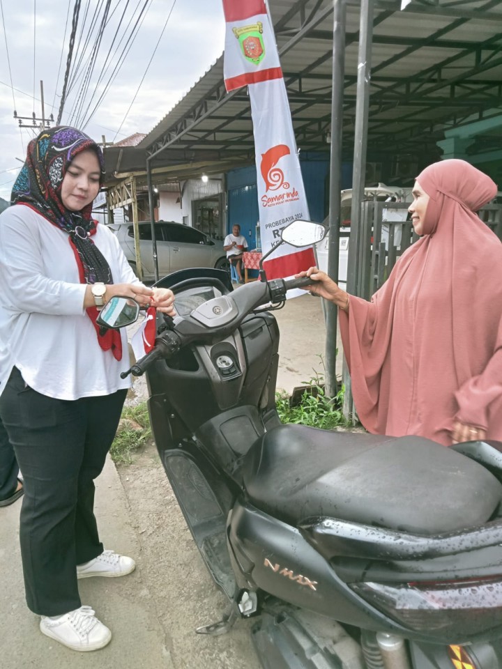 Pembagian bendera kepada warga untuk pengendara roda dua n empat,merayakan Hut RI ke 79